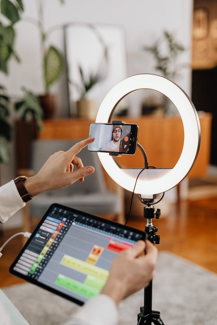 Crafting Captivating Headlines: Your awesome post title goes here A content creator uses a smartphone and ring light setup for vlogging indoors.